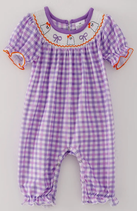 Purple checkered baby romper with decorative elements on a light gray background